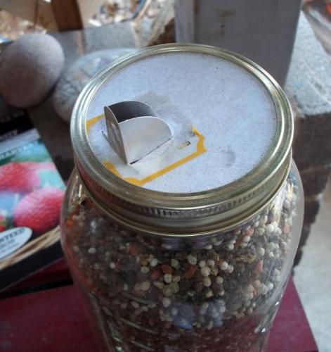 Saltbox top on jar of plant food
