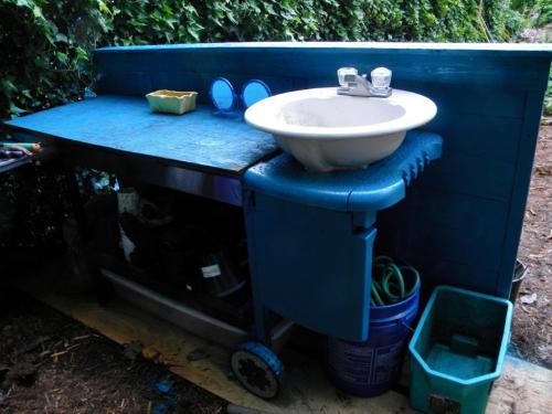 Potting bench with a new coat of paint and sink installed
