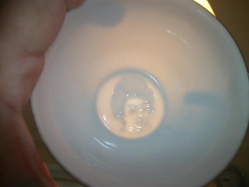 In the bottom of the cup is a geisha girl,seen when cup is empty