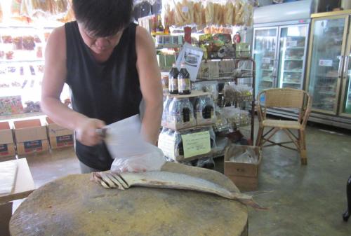 Slicing a salted fish.